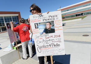 Julie Perez, of Pinole, protests outside Richmond City Hall during a visit by U.S. Attorney General Loretta Lynch on Sept. 25, 2015. Perez is seeking