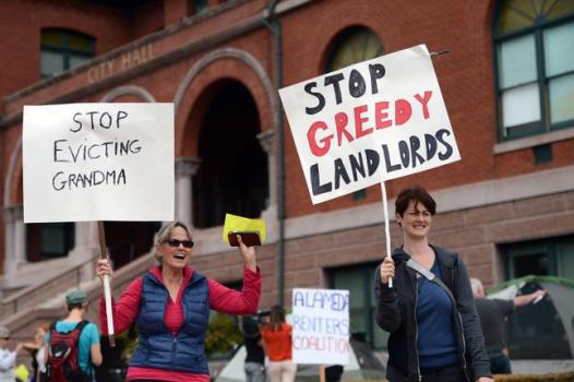Linda Weinstock, left, and Angela Hockabout, founder of the Alameda Renters Coalition, participate in a rally at City Hall to protest rent increases in Alameda on Oct. 1, 2015.