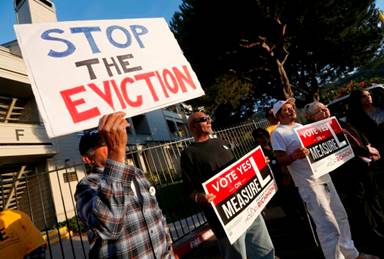 Jose Gonzalez, Vincent Justin, Luis Ugalde and former Richmond mayor Gayle McLaughlin, from left, listen to speakers as tenants rally at the  Creekview Apartments in Richmond, Calif., on Thursday, Oct. 6, 2016. Justin recently moved out after living there for 22 years. More than 100 renters are being evicted from the apartments. Tenants are demanding that the owner, PMI Properties, halt evictions and let the remaining tenants stay in the recently refurbished apartments. (Jane Tyska/Bay Area News Group)