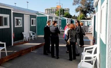 City officials and community members tour the newest Tuff Sheds community at Northgate Avenue and 27th Street in Oakland, Calif., on Monday, May 7, 2018. This is the second Tuff Sheds community opening to address the homeless crisis.  (Laura A. Oda/Bay Area News Group)