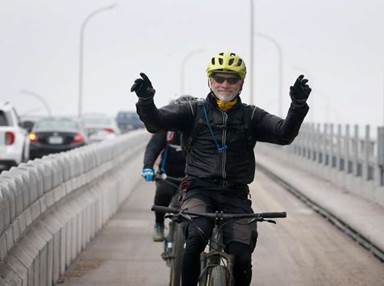 A cyclist displays his pleasure as he completes his first ride across the Richmond-San Rafael Bridge on the new bike path.